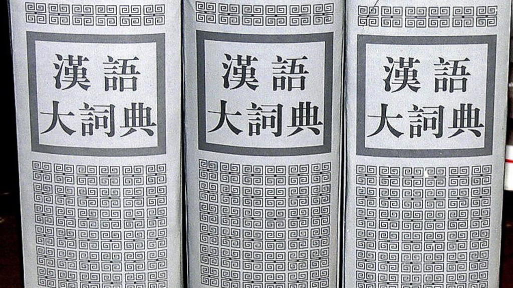 Three Chinese texts with white covers stacked side-by-side.
