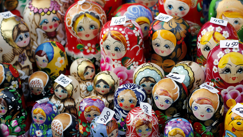 Matruschka nesting dolls for sale on a table.