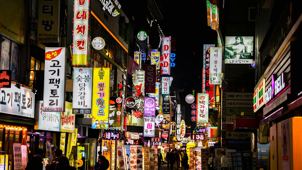 The glowing street signs at night.