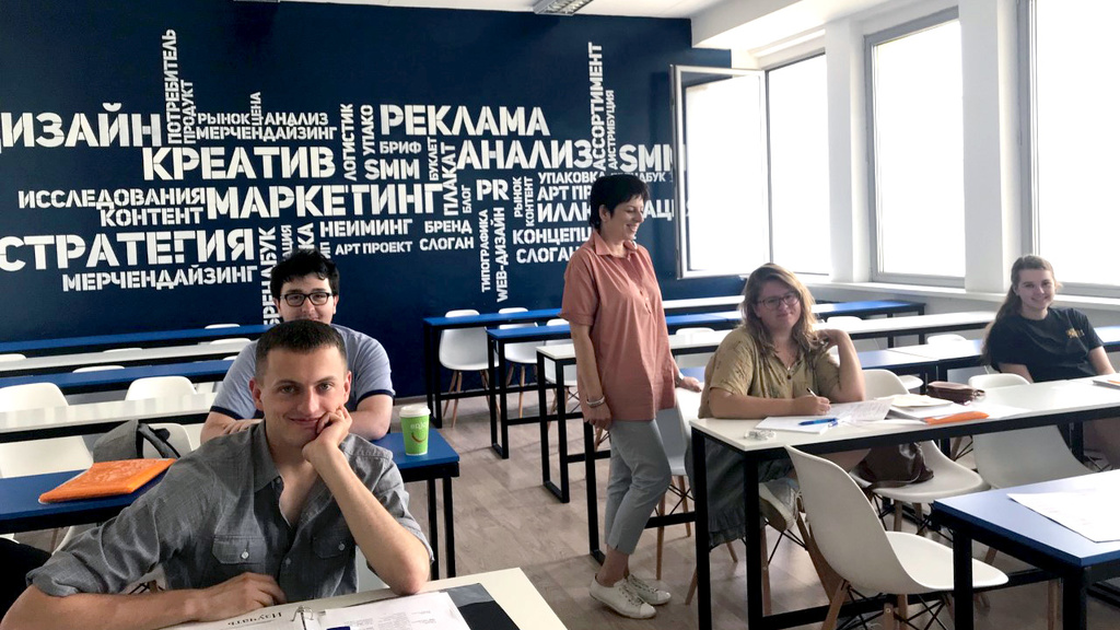 Russian students smiling in a classroom.